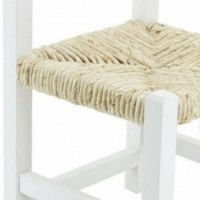 Small white wooden chair aged white with straw sitting