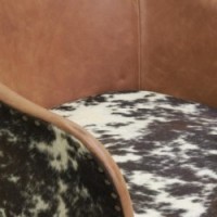 Armchair in leather and cowhide with metal legs